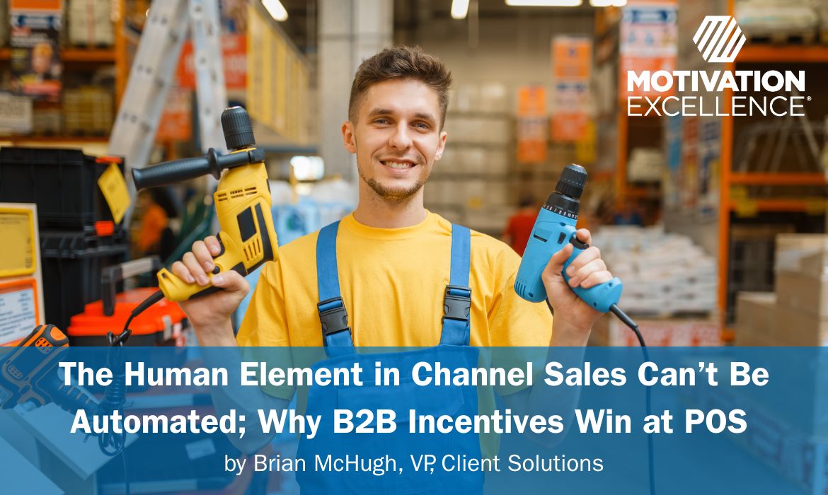 Hardware story employee is holding two power tools in his hands.